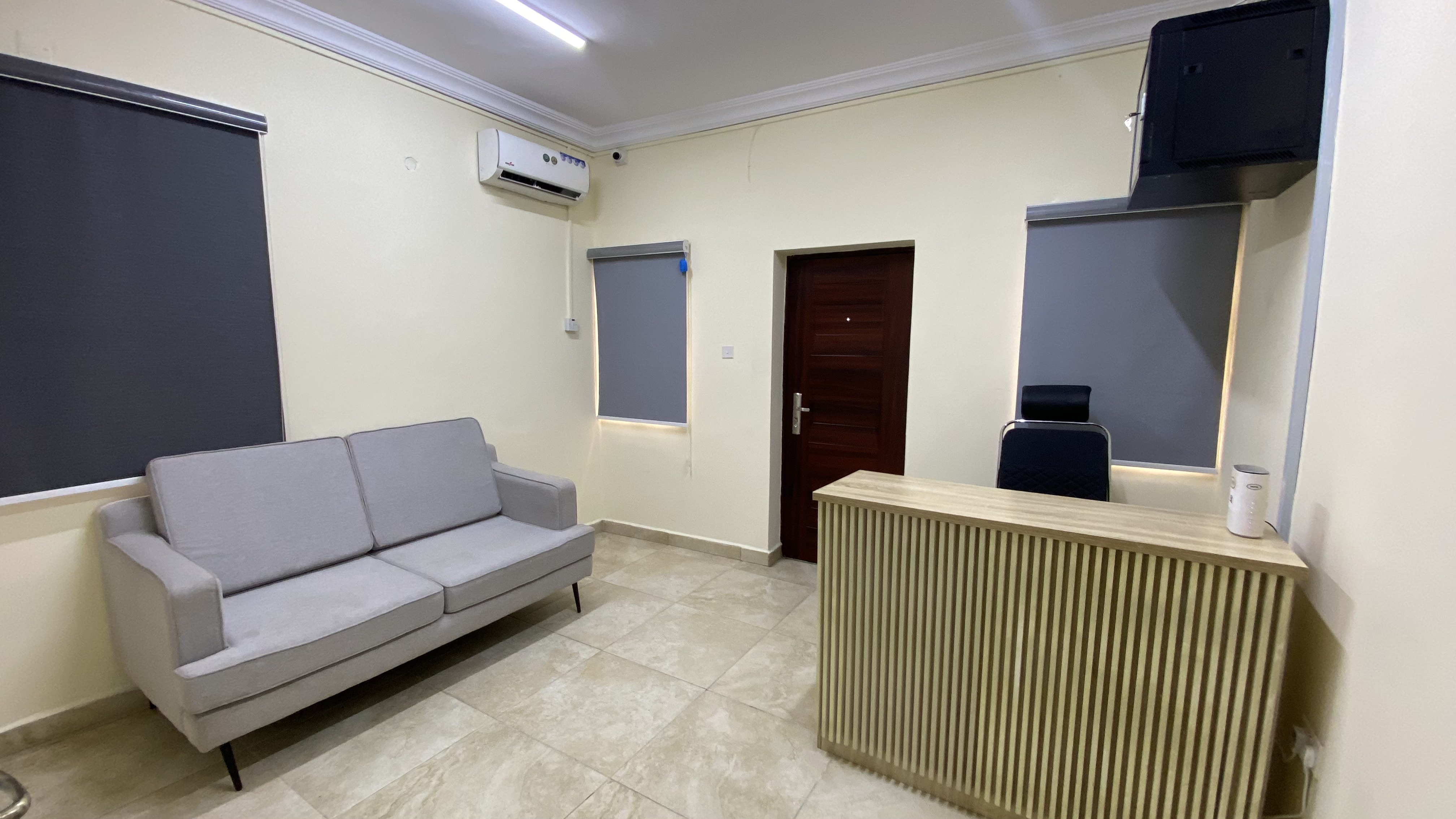 Reception area at Befitting Hub Yaba with front desk and soft seating